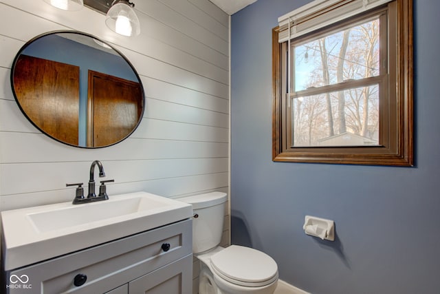 half bath featuring toilet and vanity