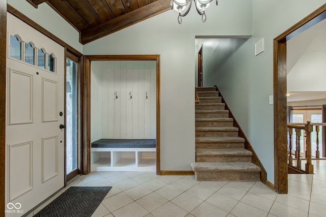 entrance foyer with wooden ceiling, vaulted ceiling with beams, visible vents, and light tile patterned floors