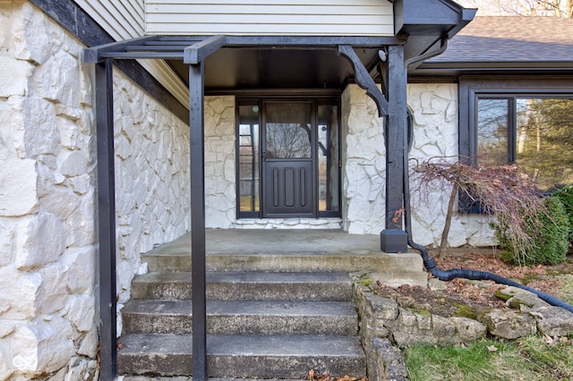 entrance to property with stone siding