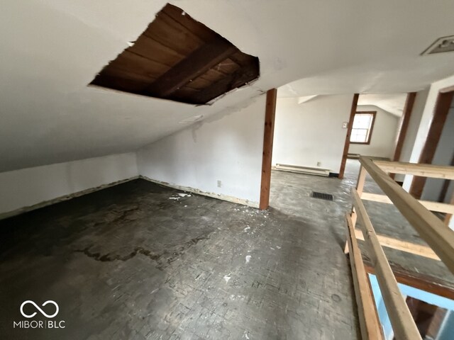 additional living space with visible vents, lofted ceiling, and a baseboard radiator