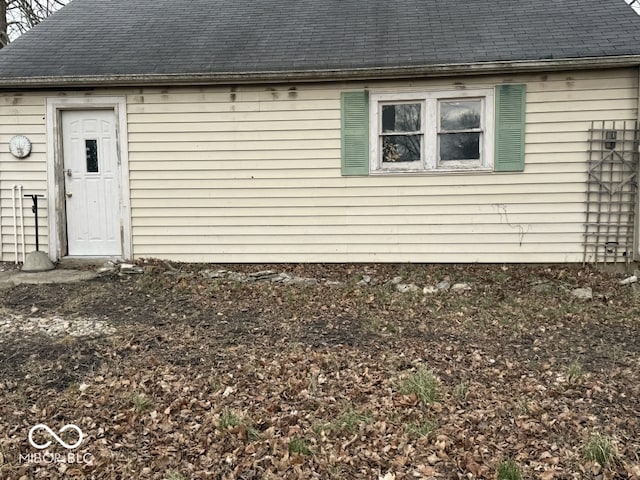 exterior space with roof with shingles