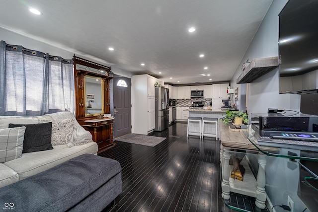 living room featuring recessed lighting and dark wood-style flooring