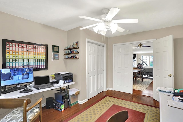 office area featuring baseboards, a ceiling fan, and wood finished floors