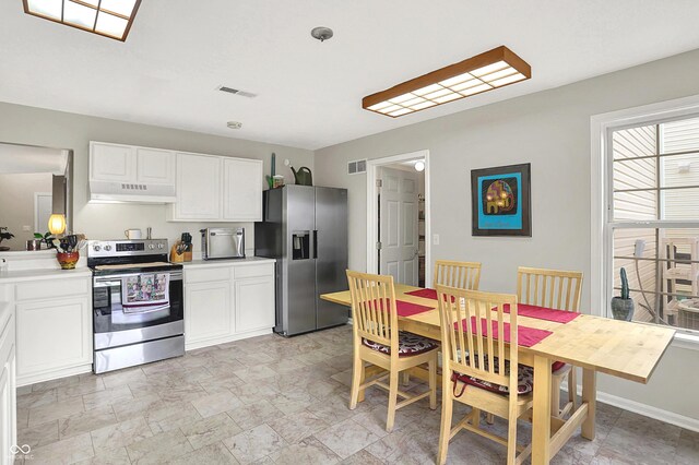 kitchen featuring white cabinets, appliances with stainless steel finishes, visible vents, and under cabinet range hood