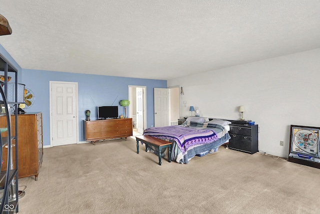 carpeted bedroom featuring a textured ceiling and baseboards