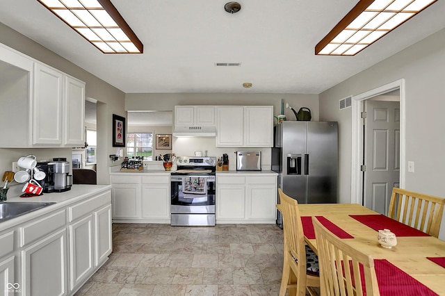 kitchen with visible vents, light countertops, appliances with stainless steel finishes, and under cabinet range hood