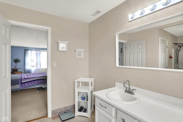 bathroom with tile patterned floors, vanity, visible vents, and connected bathroom