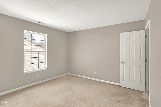 empty room with light carpet, baseboards, and visible vents