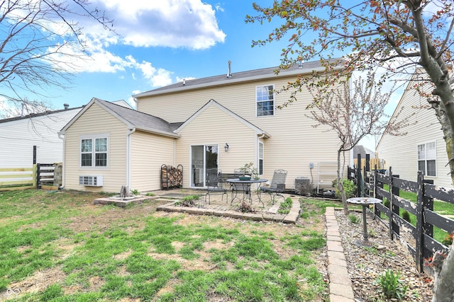 rear view of house with a yard, fence, cooling unit, and a patio area