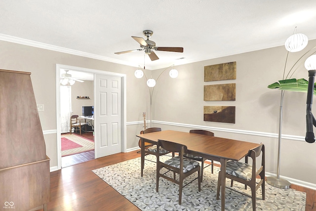 dining room with crown molding, wood finished floors, ceiling fan, and baseboards