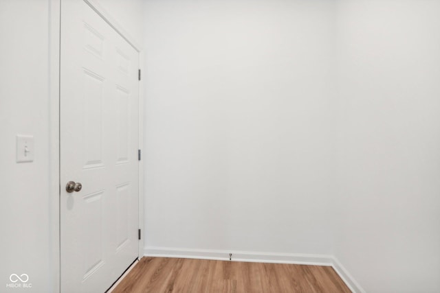 interior space featuring baseboards and light wood-style flooring