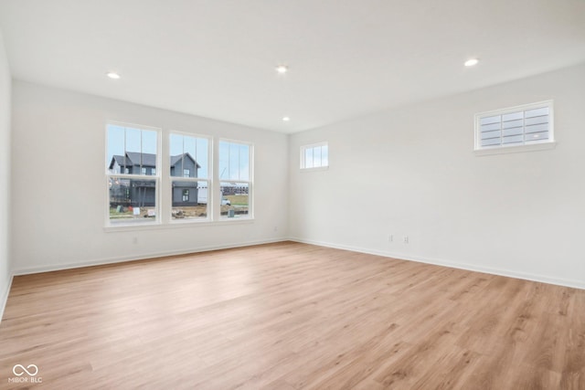 unfurnished room with recessed lighting, baseboards, and light wood finished floors