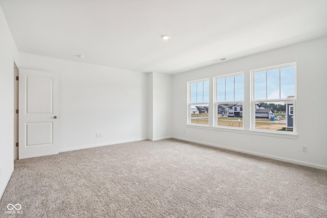 empty room with carpet flooring and baseboards