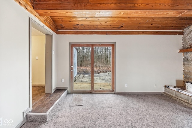 unfurnished living room with baseboards, wood ceiling, carpet flooring, and vaulted ceiling