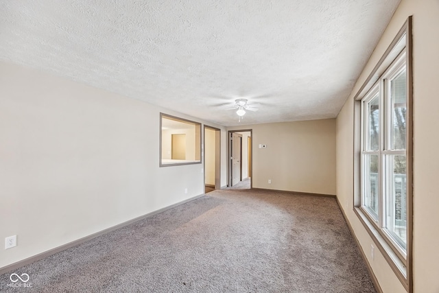 unfurnished room featuring ceiling fan, carpet, baseboards, and a textured ceiling