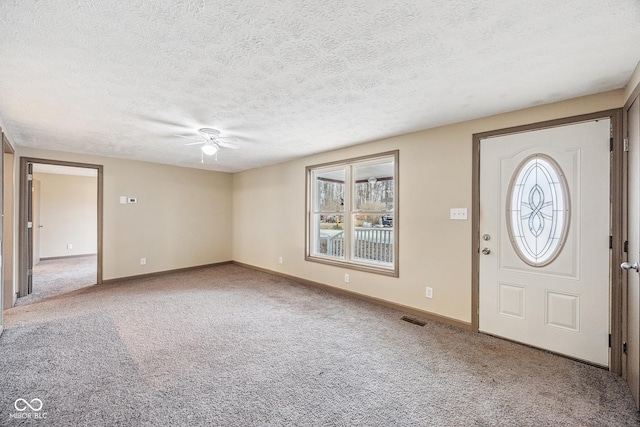 carpeted foyer with visible vents, plenty of natural light, and baseboards