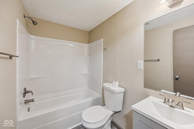 full bath with vanity,  shower combination, toilet, and a textured ceiling