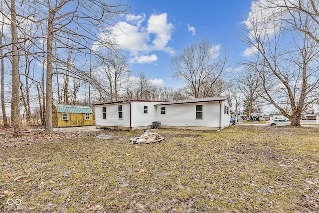 rear view of property with metal roof