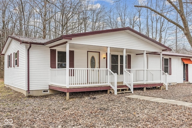 view of front of home featuring metal roof, covered porch, and crawl space