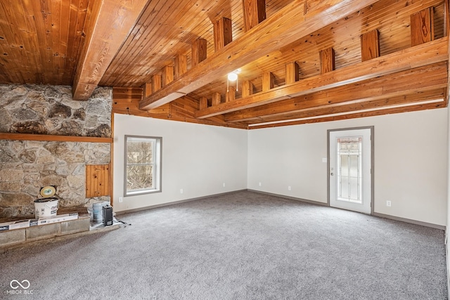 unfurnished living room with beam ceiling, wood ceiling, carpet, and baseboards