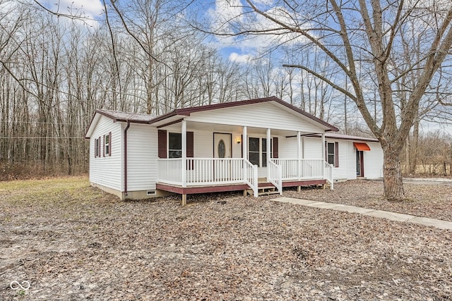 view of front of property with crawl space, covered porch, and metal roof