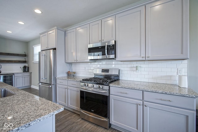 kitchen featuring open shelves, backsplash, dark wood finished floors, stainless steel appliances, and light stone countertops