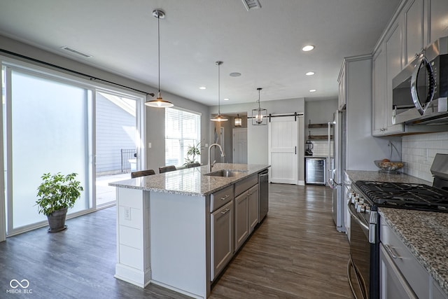 kitchen featuring a sink, gray cabinets, and stainless steel appliances