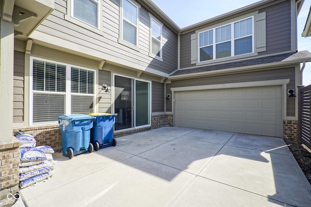 view of patio / terrace featuring a garage and driveway