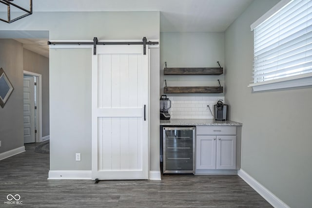 bar featuring decorative backsplash, wine cooler, baseboards, and dark wood-style flooring