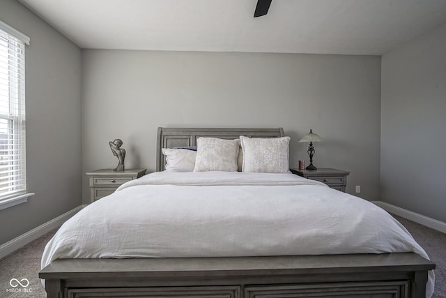 carpeted bedroom featuring multiple windows, baseboards, and ceiling fan