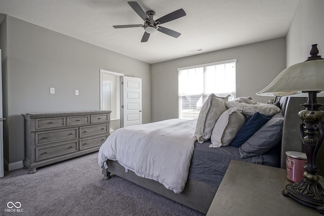 bedroom featuring a ceiling fan, visible vents, baseboards, ensuite bathroom, and carpet flooring