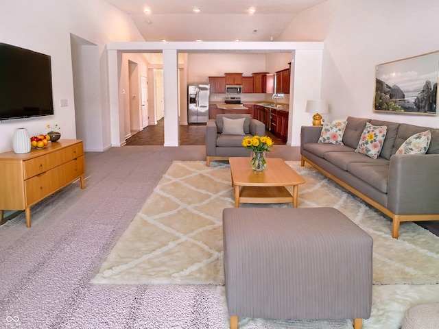 living room featuring recessed lighting, light carpet, and vaulted ceiling