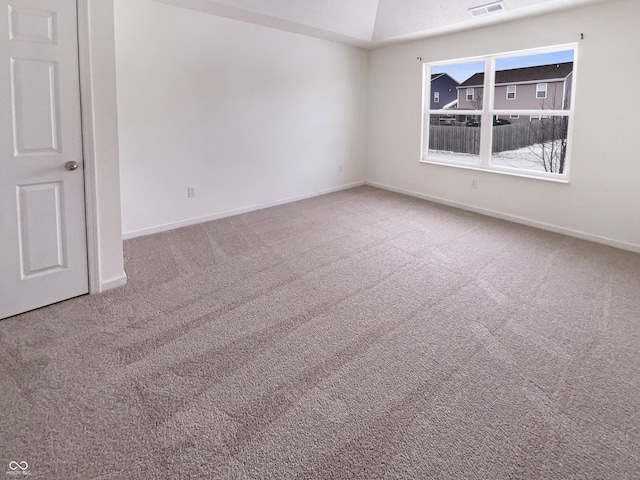 carpeted empty room with visible vents and baseboards