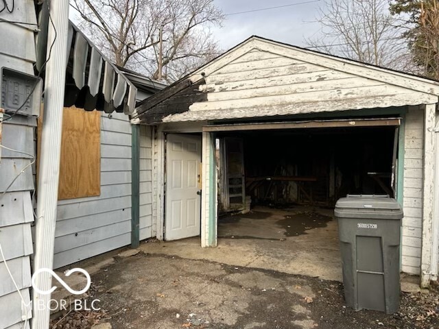 view of side of home with a detached garage and an outdoor structure