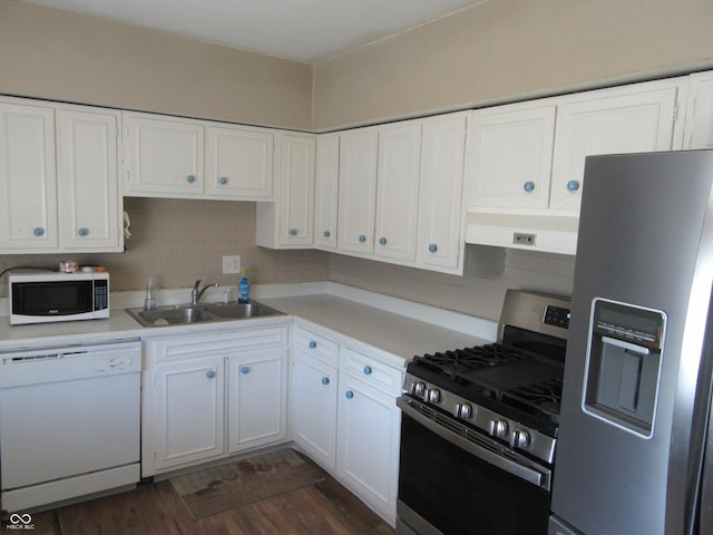 kitchen featuring a sink, stainless steel appliances, under cabinet range hood, and white cabinetry