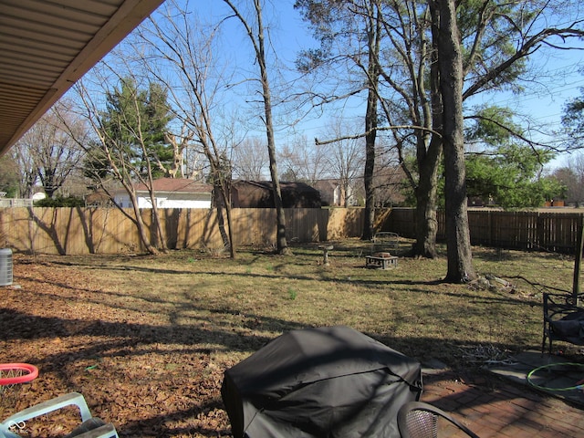 view of yard with a fire pit and a fenced backyard