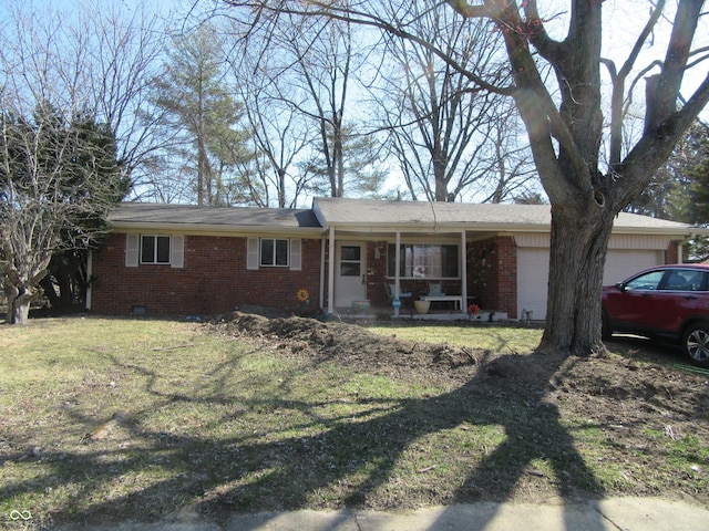 ranch-style home featuring an attached garage, covered porch, a front lawn, crawl space, and brick siding