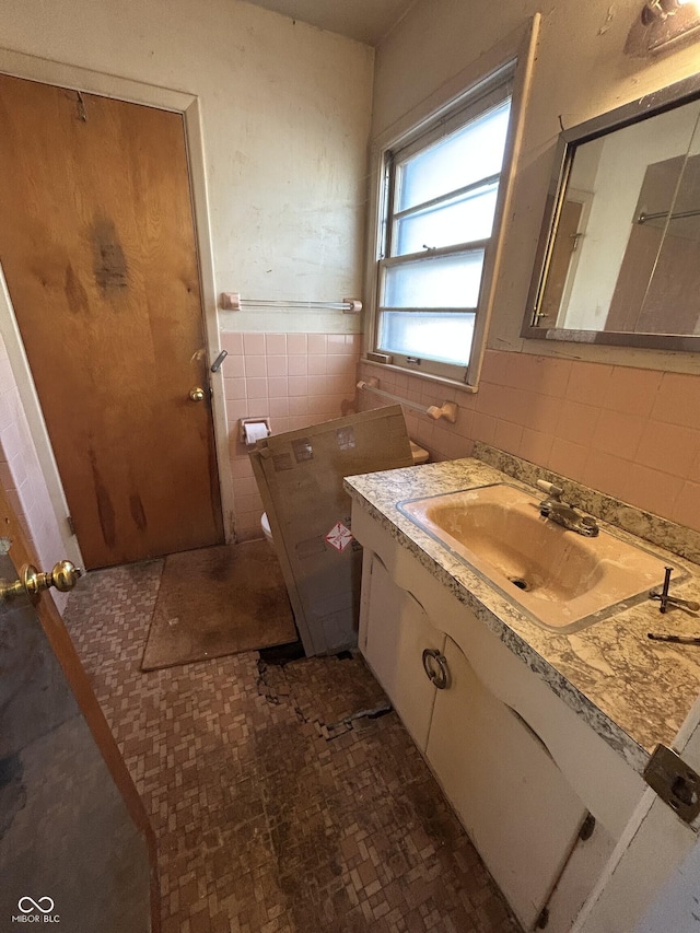 bathroom featuring vanity, tile walls, and a wainscoted wall