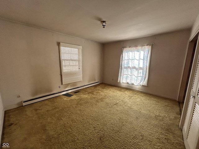 unfurnished bedroom featuring baseboard heating and carpet floors