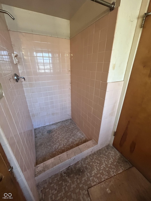 full bath with a tile shower