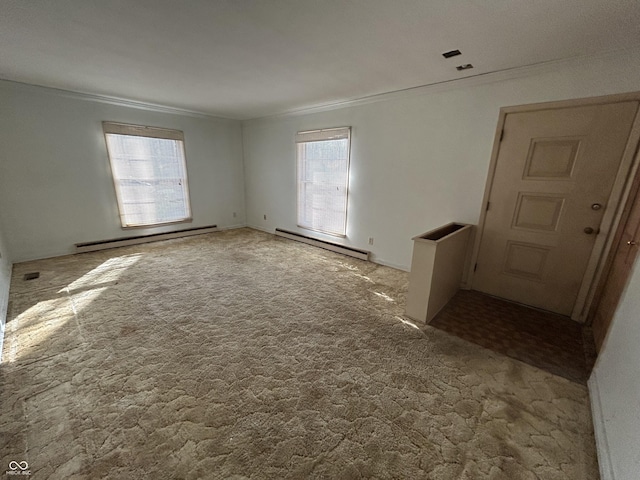 carpeted empty room with a baseboard heating unit and ornamental molding