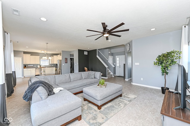 living area featuring visible vents, recessed lighting, stairs, and baseboards