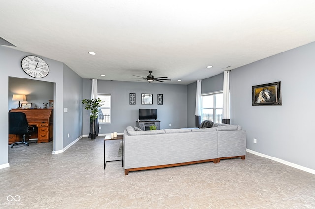 living area with recessed lighting, ceiling fan, and baseboards