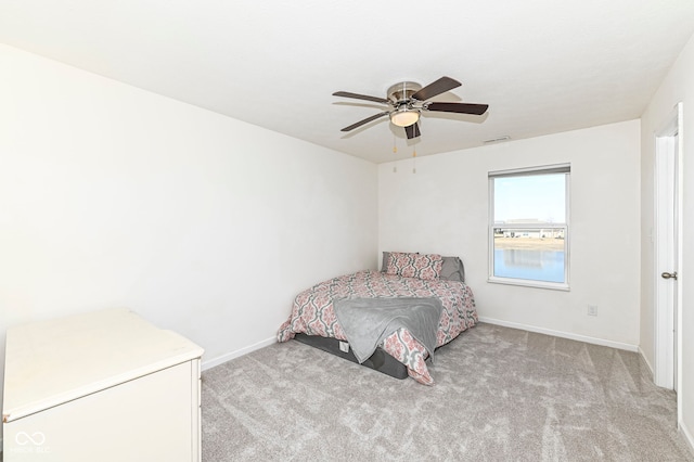 bedroom featuring ceiling fan, baseboards, visible vents, and light carpet