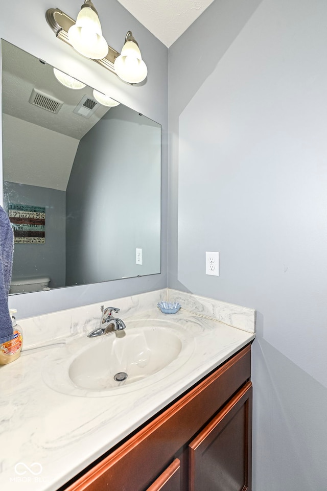 bathroom featuring visible vents and vanity