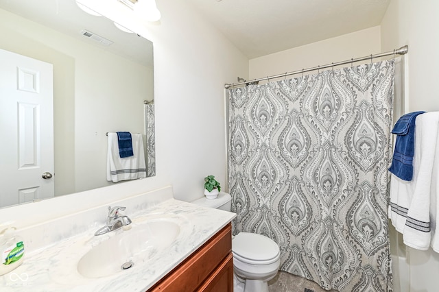 bathroom with visible vents, toilet, vanity, and a shower with curtain