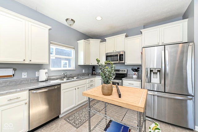 kitchen featuring white cabinetry, light countertops, and stainless steel appliances