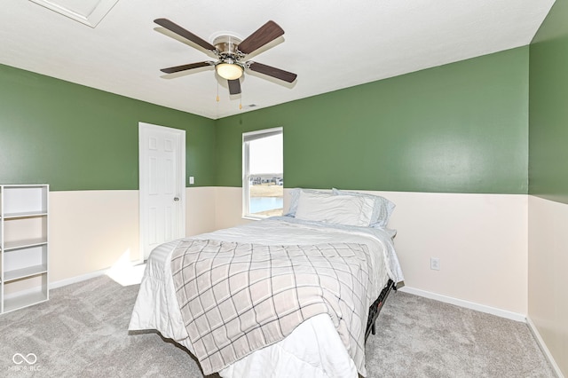 carpeted bedroom with baseboards and a ceiling fan