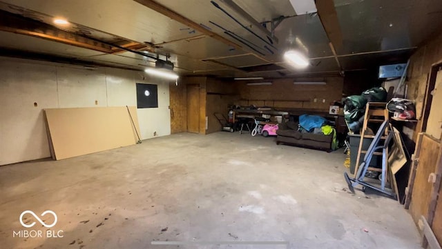 garage with electric panel and a garage door opener