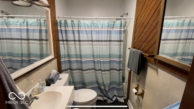 full bathroom with shower / bath combination with curtain, toilet, and vanity